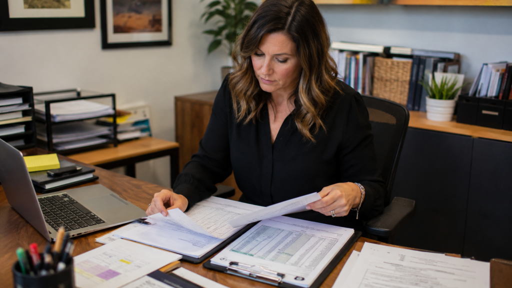 Fundraising coordinator organizing silent auction templates and event planning documents