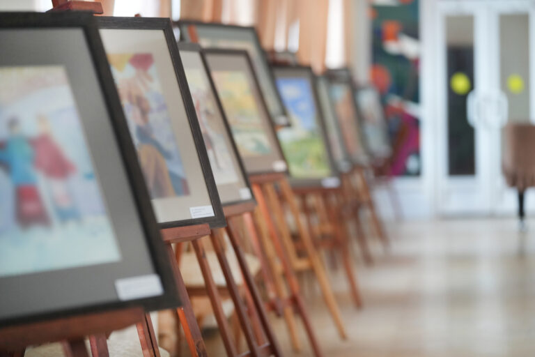 nonprofit silent auction event setup with bid sheets and auction items displayed on tables