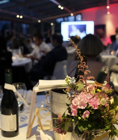 Guest writing a bid on a silent auction bid sheet at a charity fundraiser